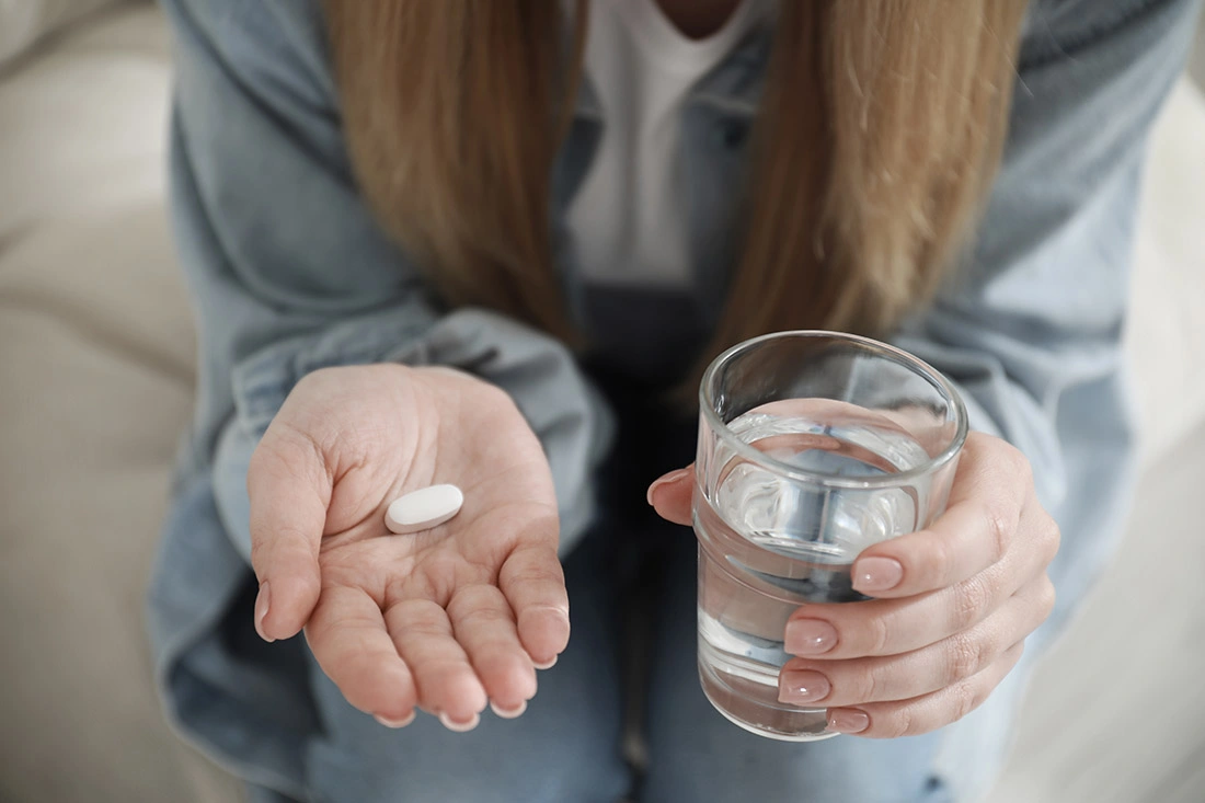 A woman holding a medical abortion pill